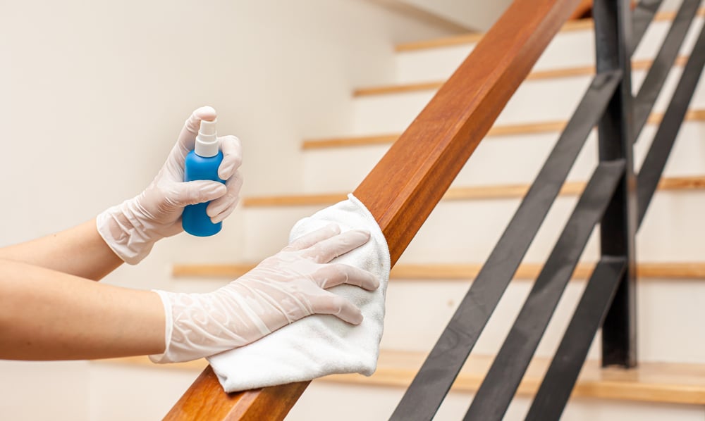 Deep cleaning with alcohol disinfectant spray on Wipes of Banister in home for safety