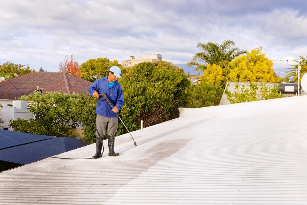 A,Man,Doing,High,Pressure,Spray,Cleaning,Of,A,Roof