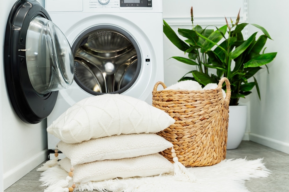 Laundry,Basket,And,Pile,Of,White,Pillows,In,Front,Of