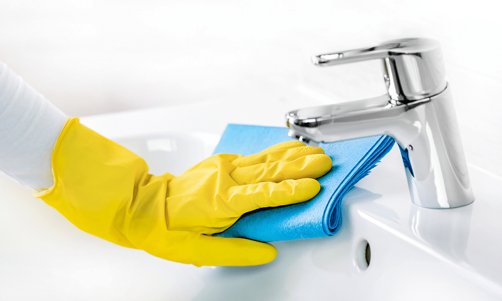 a women cleaning the sink